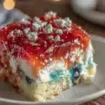 red white and blue layered jello poke cake - featured image